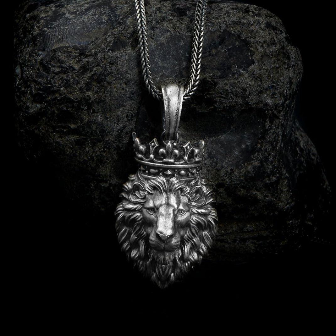 sterling silver lion necklace showcasing a finely detailed lion's face crowned with a regal tiara, encapsulating strength and royalty in one design.