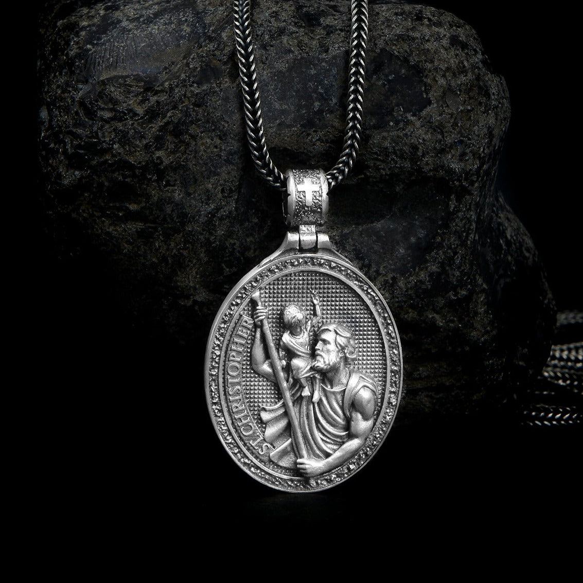 Lustrous sterling silver pendant featuring an intricately detailed Saint Christopher, evoking protection and adventure, suspended on a sleek chain.