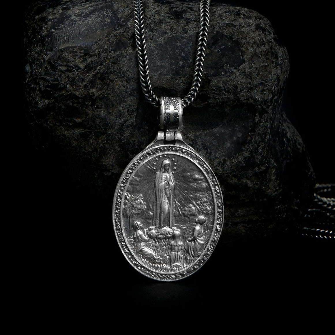 Detailed Sterling Silver Virgin Mary pendant hanging gracefully on a delicate chain, symbolizing purity and divine motherhood.