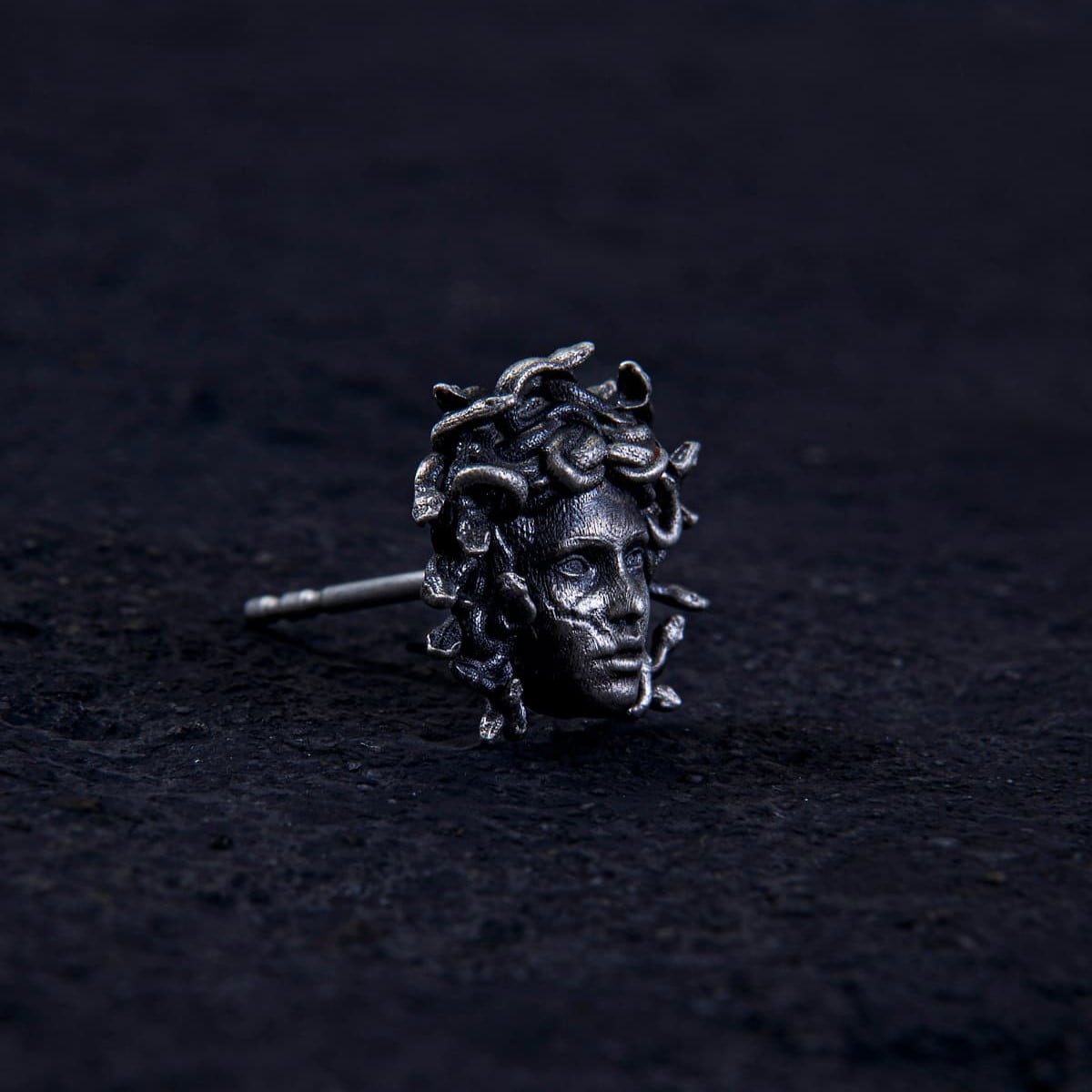 Unleash ancient power with the Gordon Medusa Earring. Crafted from solid sterling silver, this striking stud showcases the fierce face of Medusa crowned with venomous serpents.