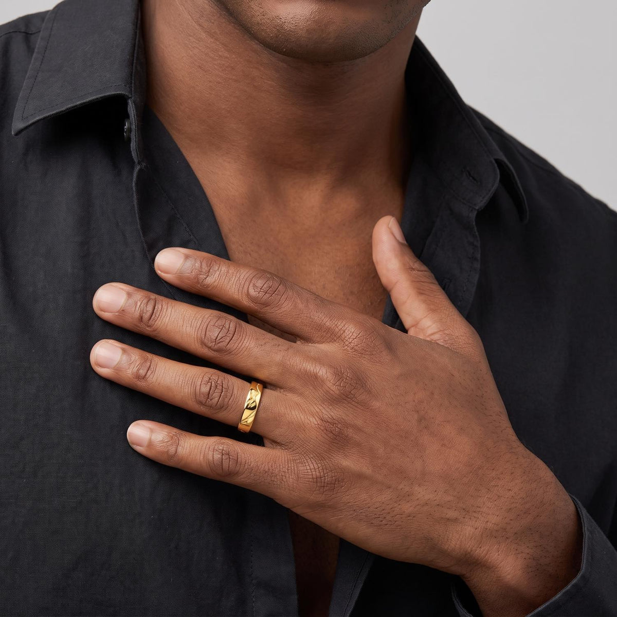 Worn Band Ring on male model, gold finish, on chest