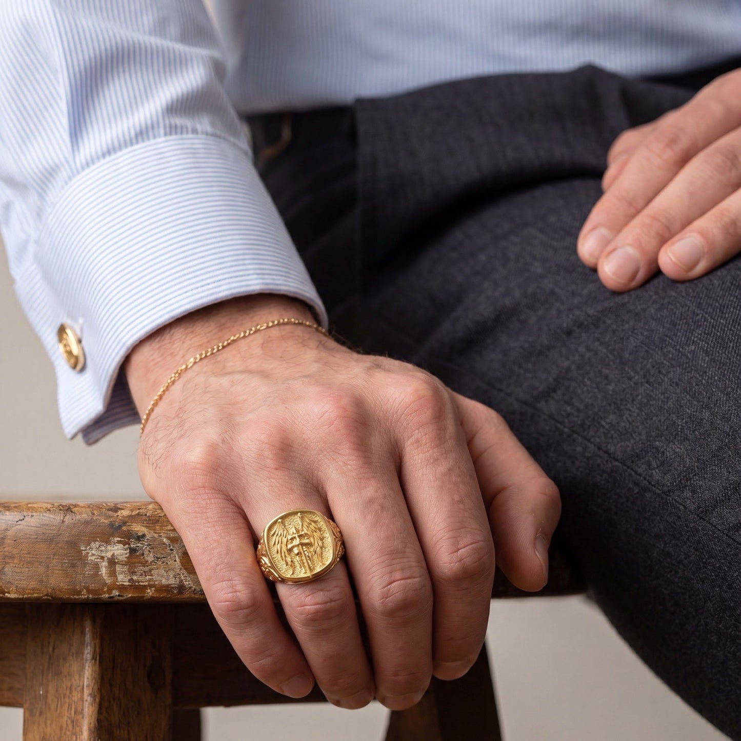 Close-up of the 18k gold Saint Michael signet ring worn on a man's hand