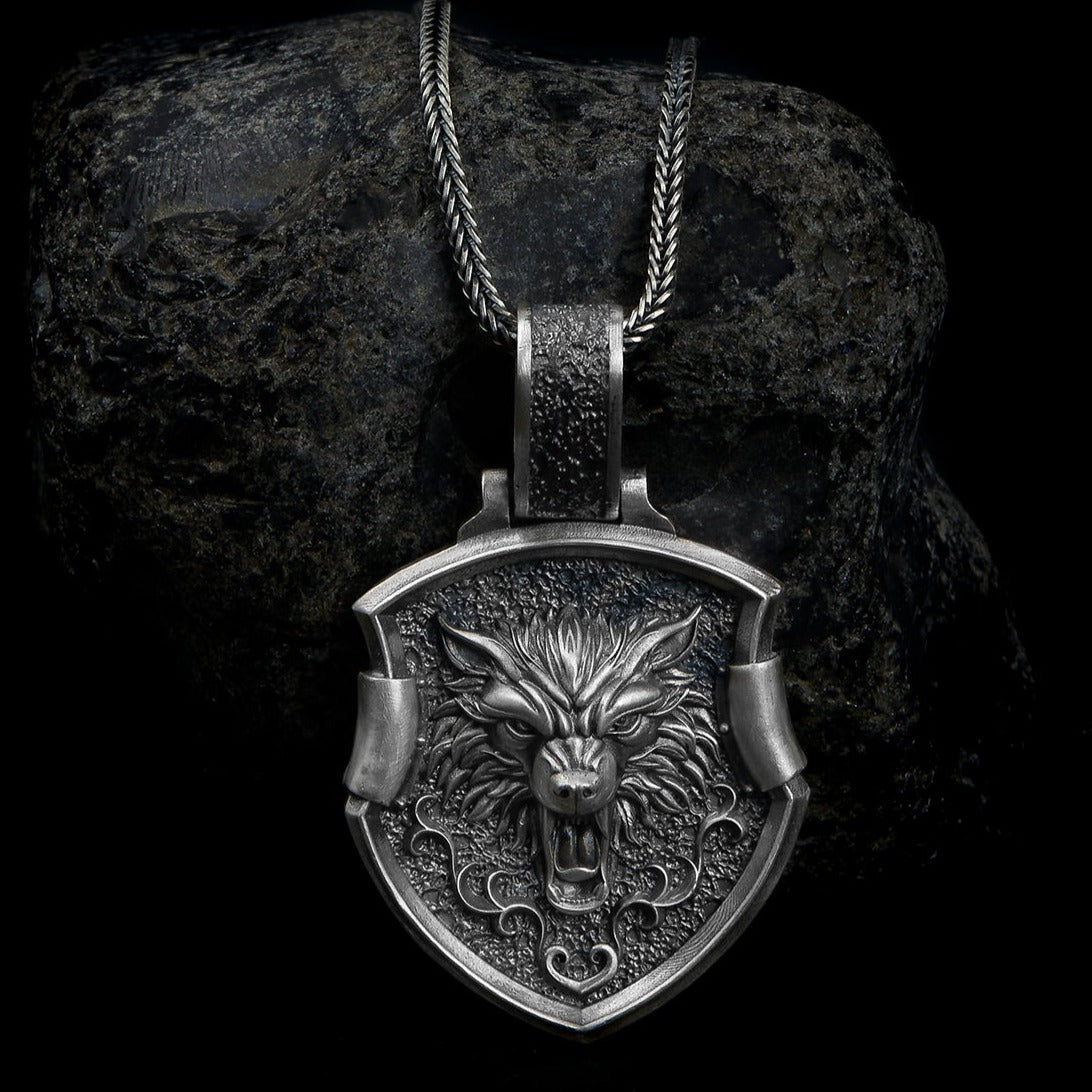 Detailed Sterling Silver Wolf Necklace pendant, showcasing a beautifully engraved wolf's head and tooth within a pentagon frame