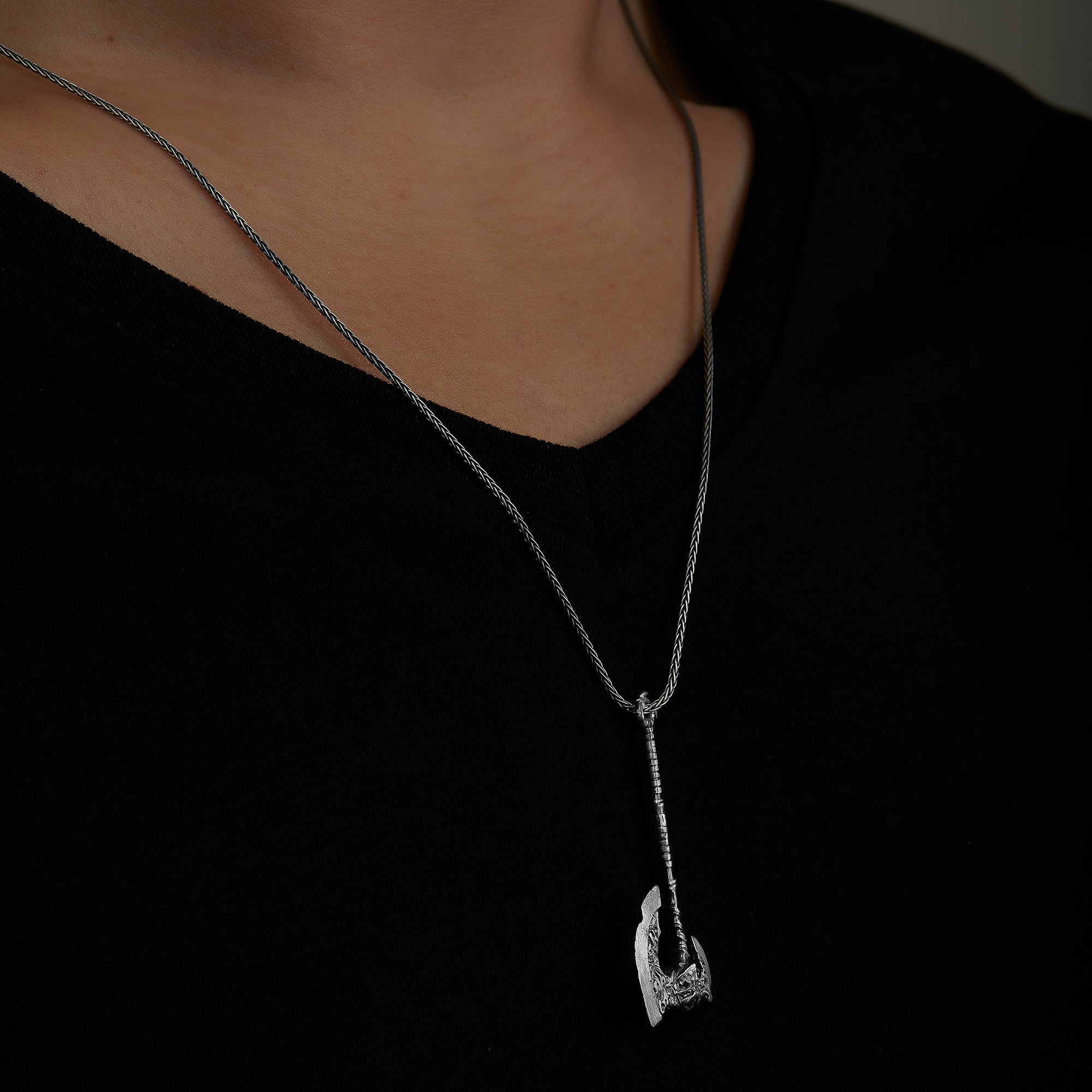 handmade sterling silver Worn Axe Necklace on the neck preview
